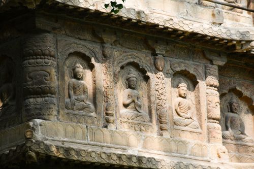 Free Close-up of detailed Buddha carvings on an ancient temple facade. Stock Photo