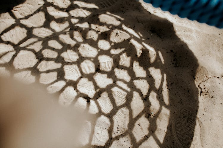 Photo Of A Swing Shadow On Sand