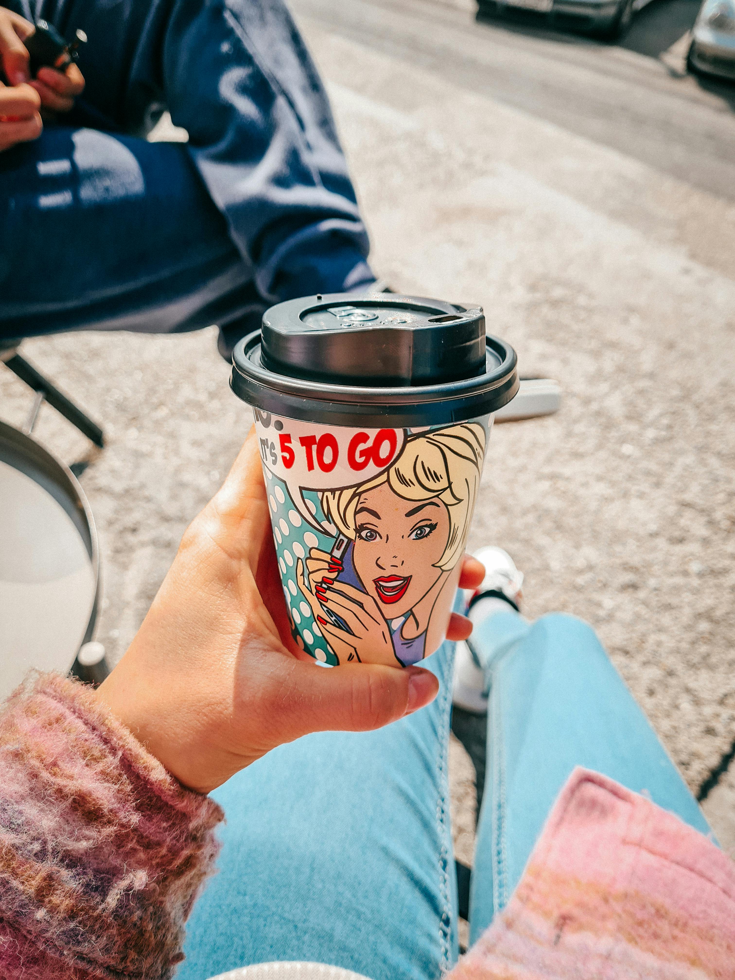 a person holding a cup of coffee