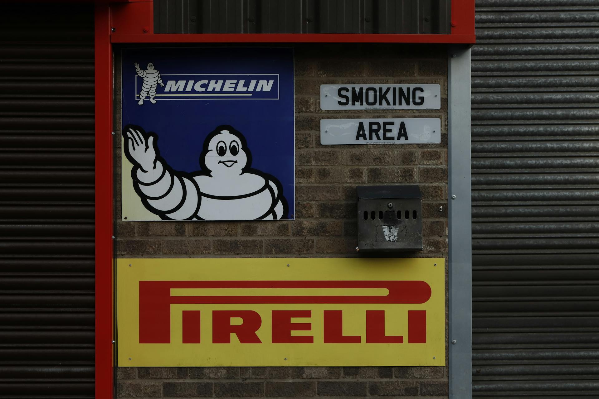 Pirelli and Michelin Logos on Wall