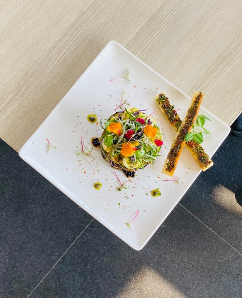 Top View of an Elegantly Served Salad on a White Square Plate 