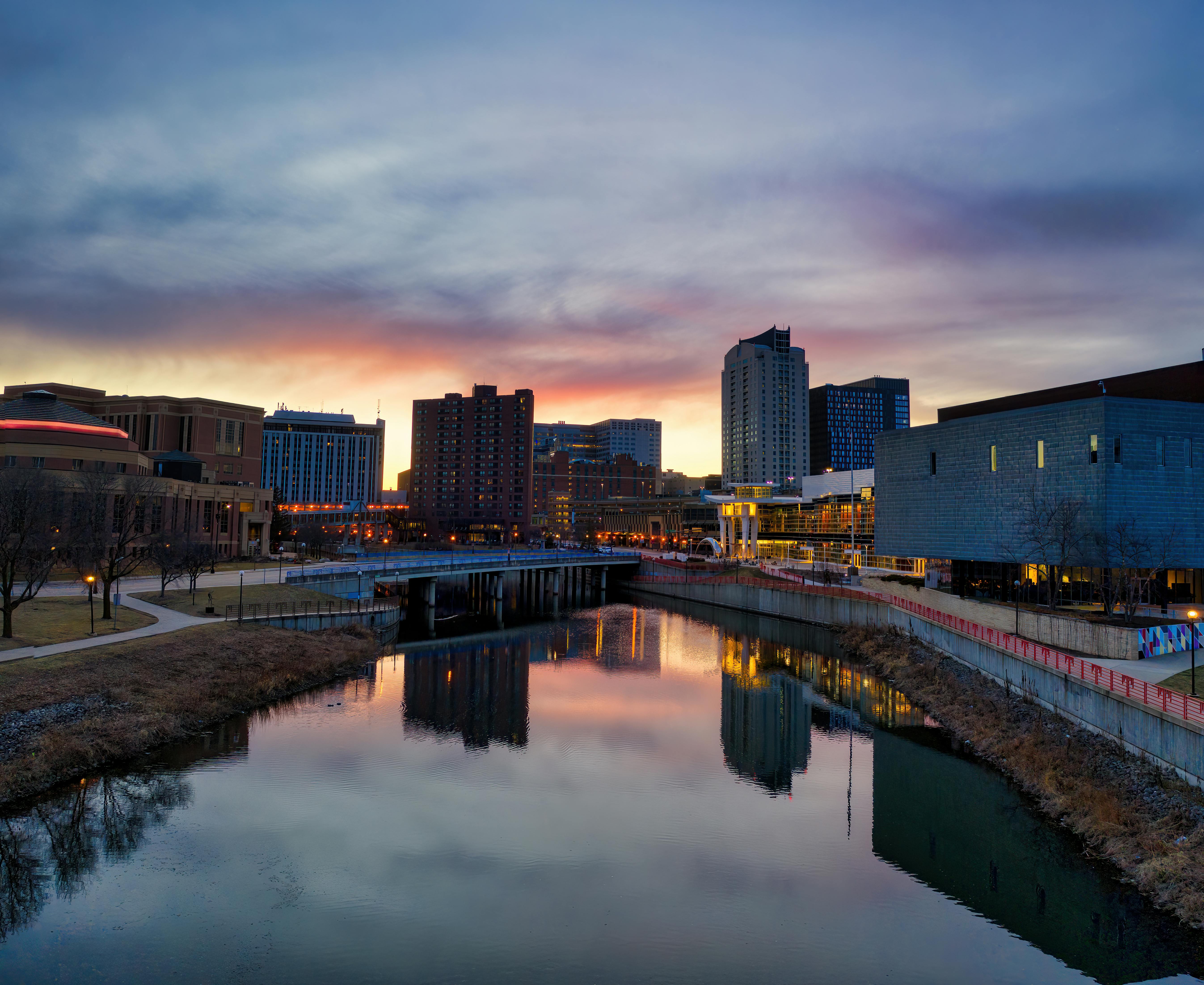 Stunning twilight view of Rochester, MN skyline reflecting on the river.