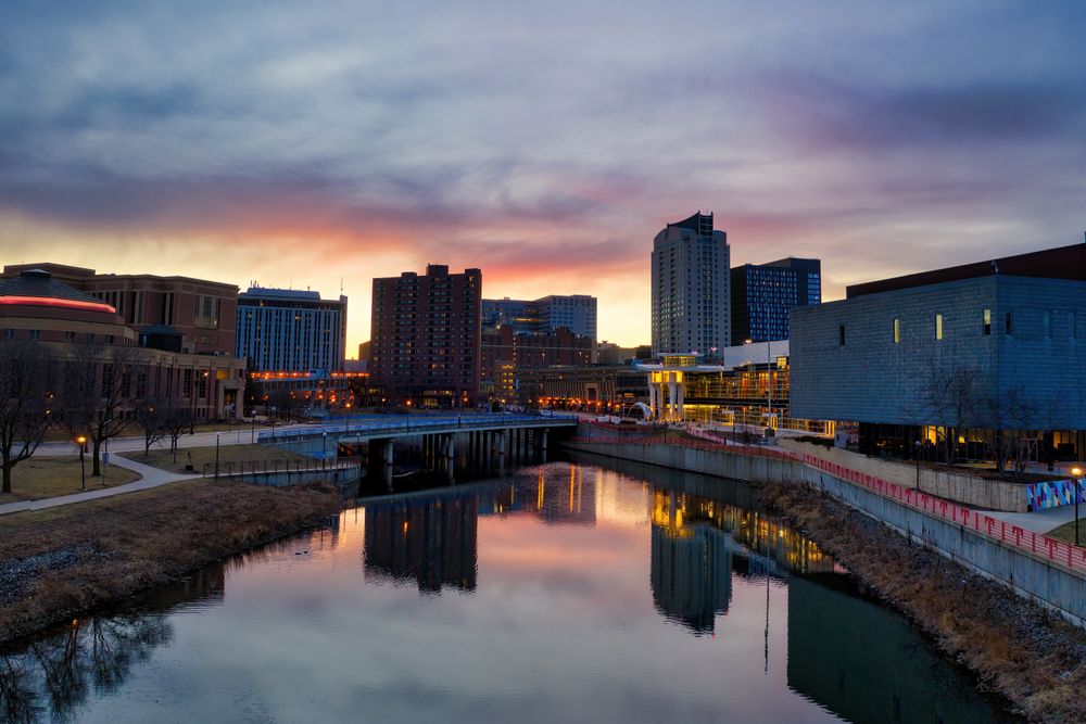 Stunning twilight view of Rochester, MN skyline reflecting on the river.