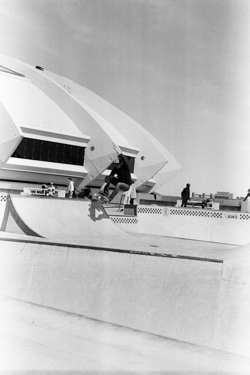 Black and White Picture of a Skateboarder Doing Tricks