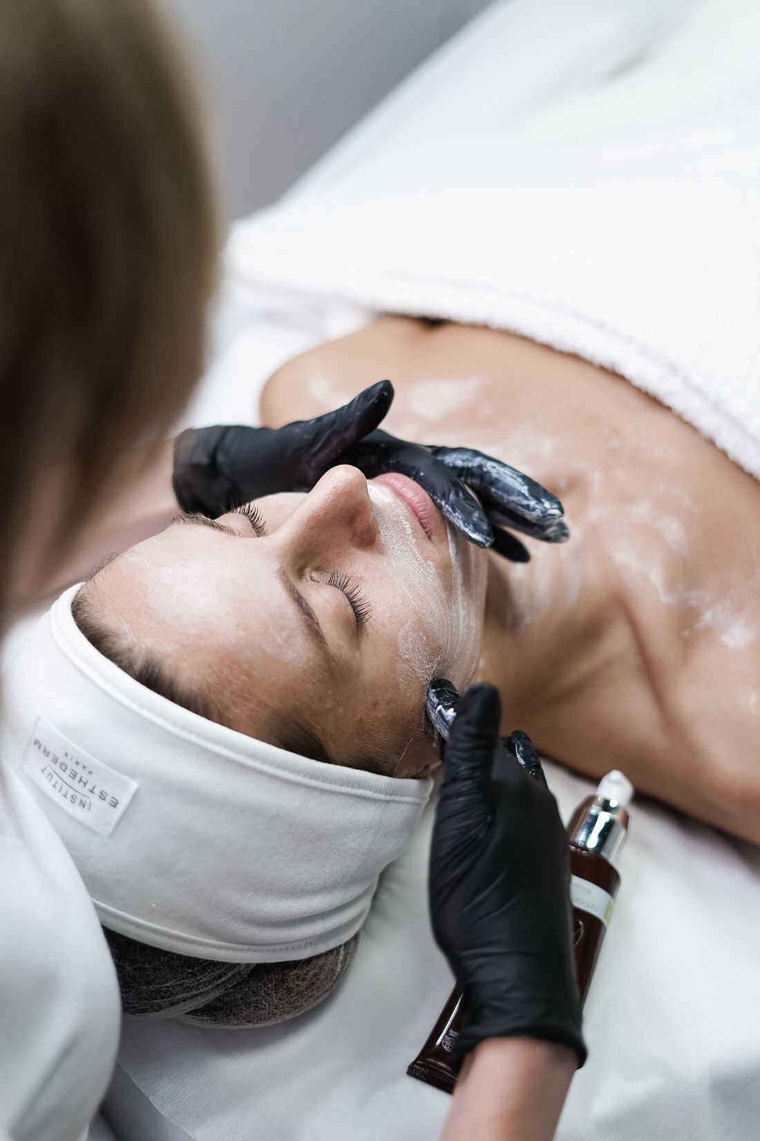 Woman relaxing during a personalized facial treatment at a spa