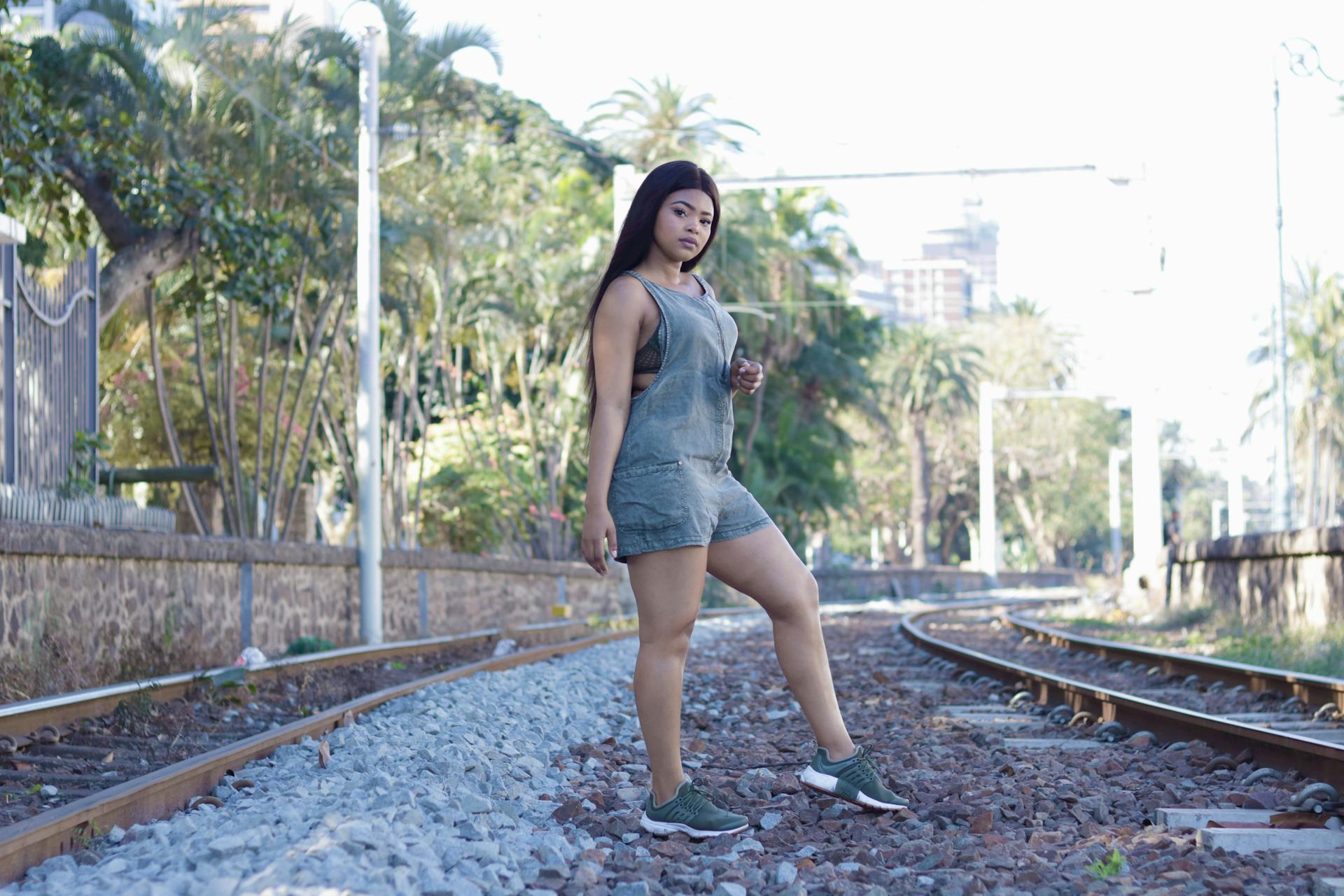 Fashion portrait of a woman posing on railway tracks in Durban, South Africa.