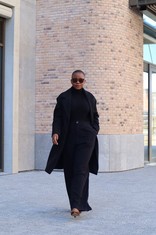 A Woman in Black Clothing Walking