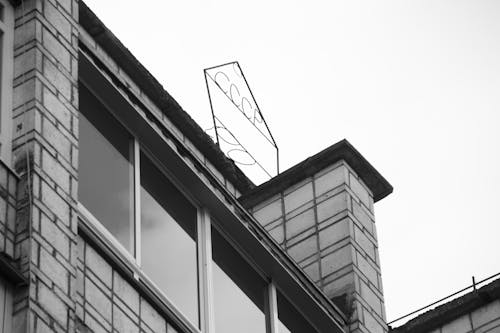 Grayscale Photo of a Building with Glass Windows