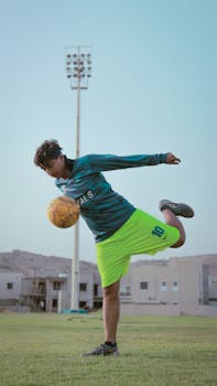 A young male soccer player practicing in an outdoor field in Karachi, Pakistan.