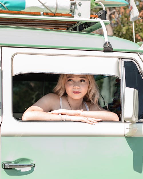 Young Blonde Woman Sitting in a Volkswagen T1 
