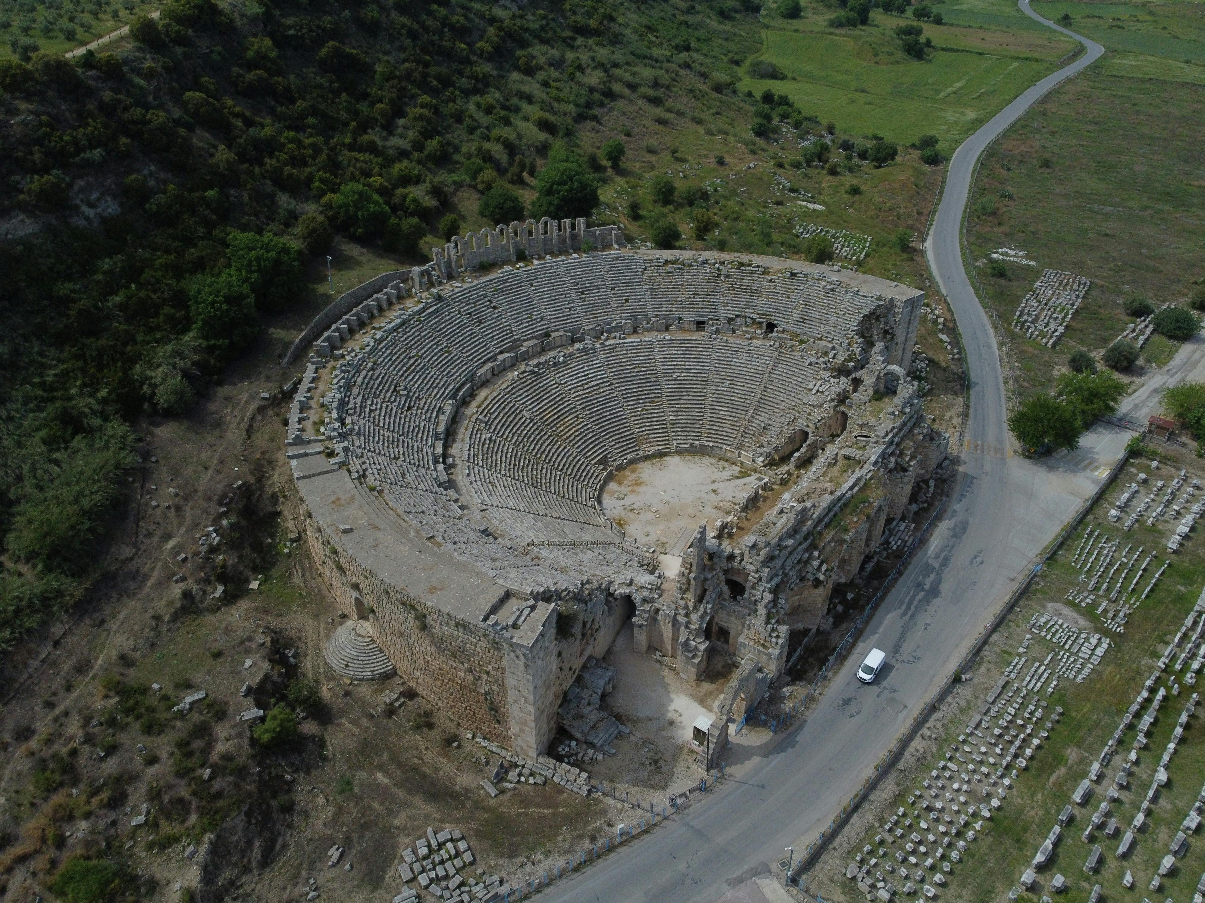 Free Drone shot of a historic amphitheater in Turkey showcasing ancient architecture. Stock Photo