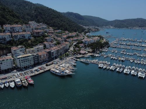 Free Captivating aerial shot of Turkish marina with yachts and scenic coastal landscape. Stock Photo
