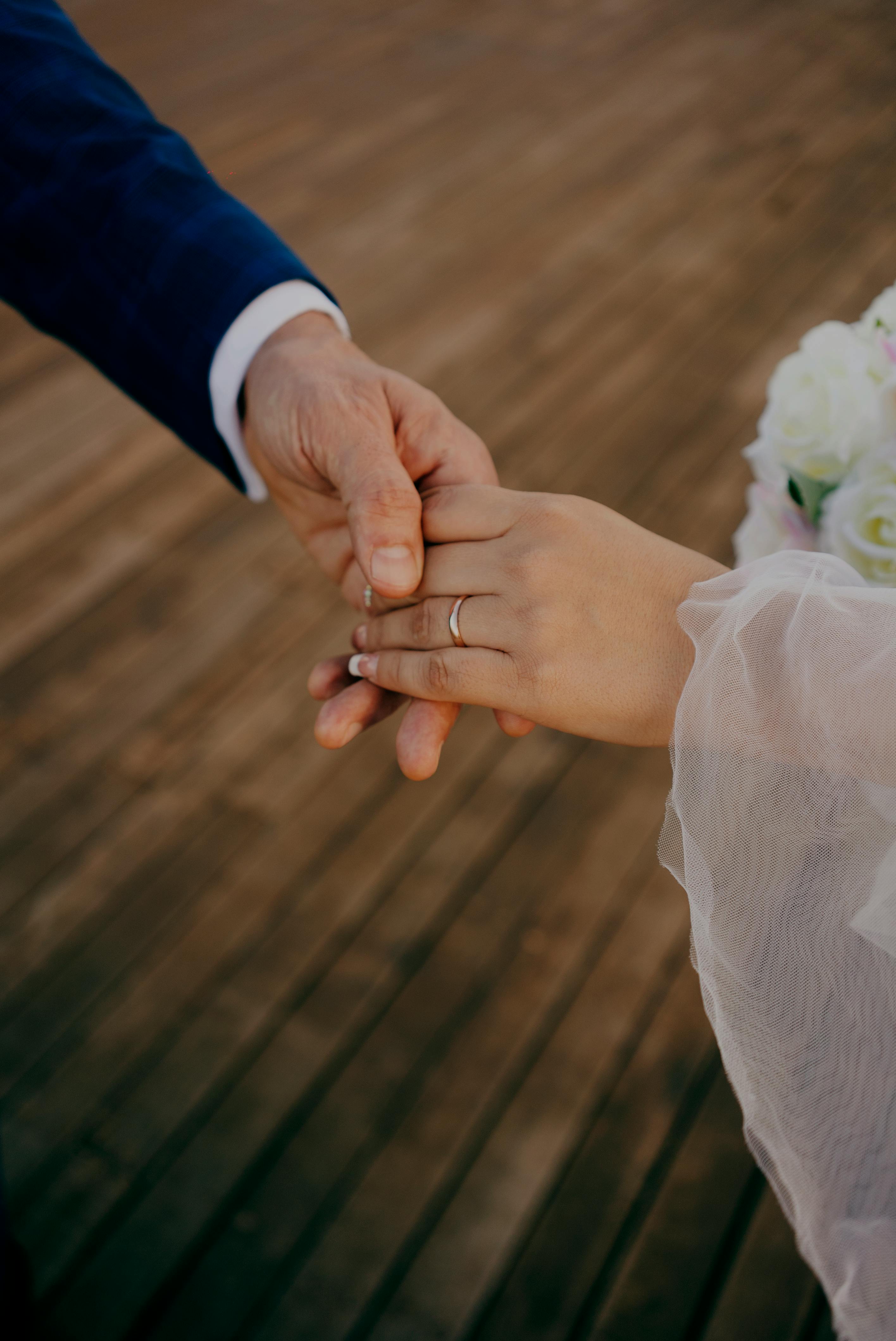 real bride and groom holding hands