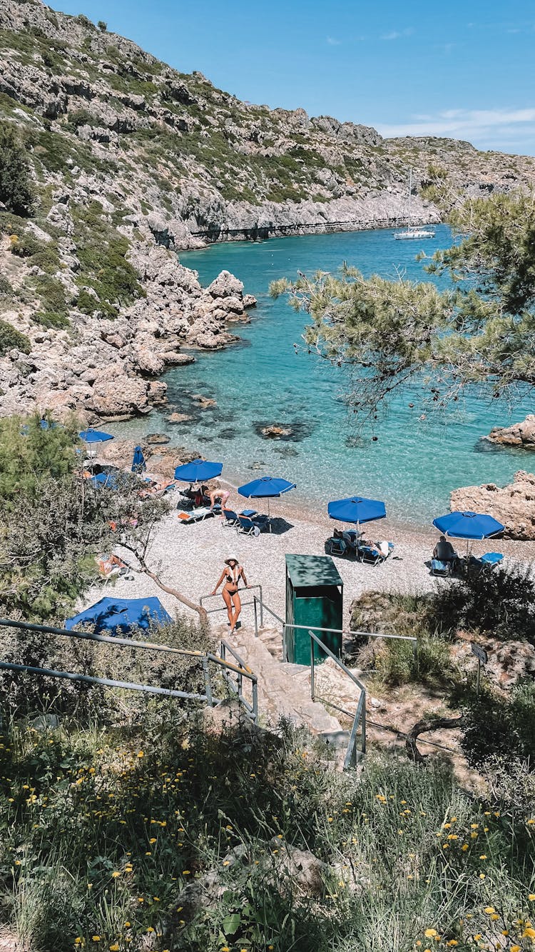 Beach Resort With Blue Umbrellas On Shore