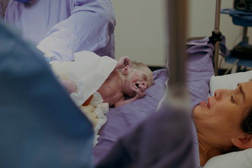 Free Mother and Newborn Baby In Hospital Just After Labor Stock Photo