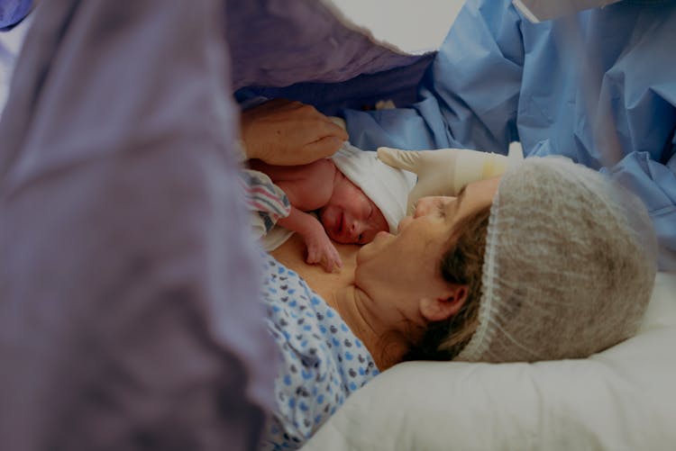 Woman Holding Her Newborn After Giving Birth