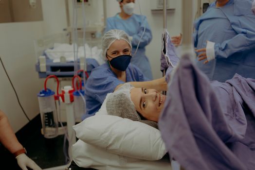 Happy Mother and Nurses During Caesarean Section