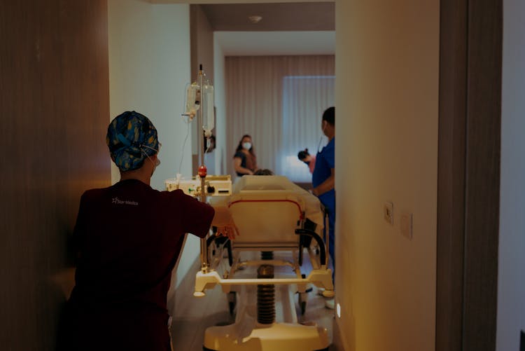 Nurses Walking With Hospital Bed 