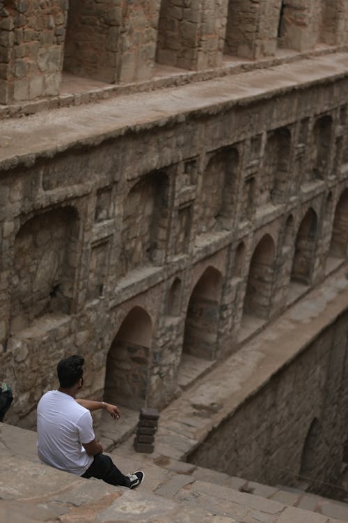 Back View of Man Sitting on Steps in Agrasen Ki Baoli, New Delhi, India