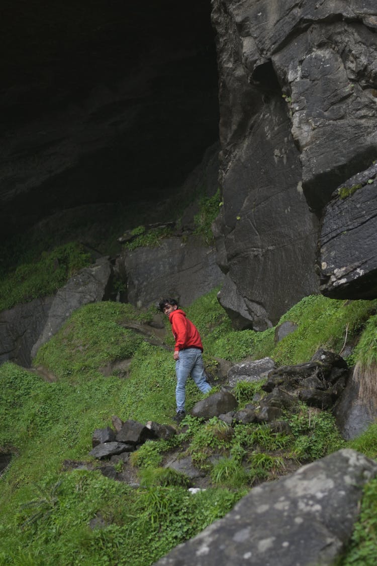 Man Hiking Up The Rocks