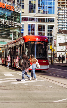 Pedestrians and a streetcar captured in lively downtown Toronto, Canada.