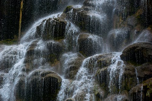Close-up of Water Flowing Down on Rocks 