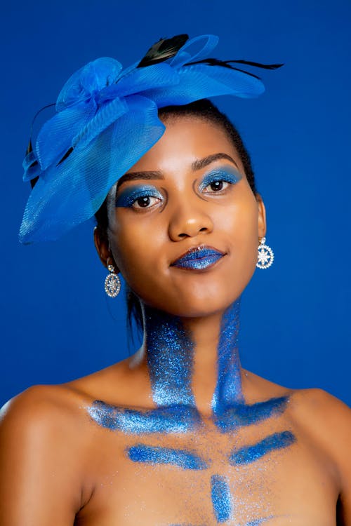 Woman With Blue Eye Shadow and Glitters on Lips  and Body 