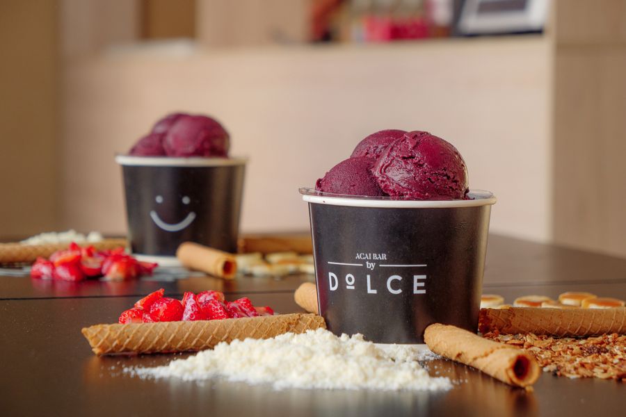 Close-up of a delicious acai bowl with various toppings including fruits and wafers.