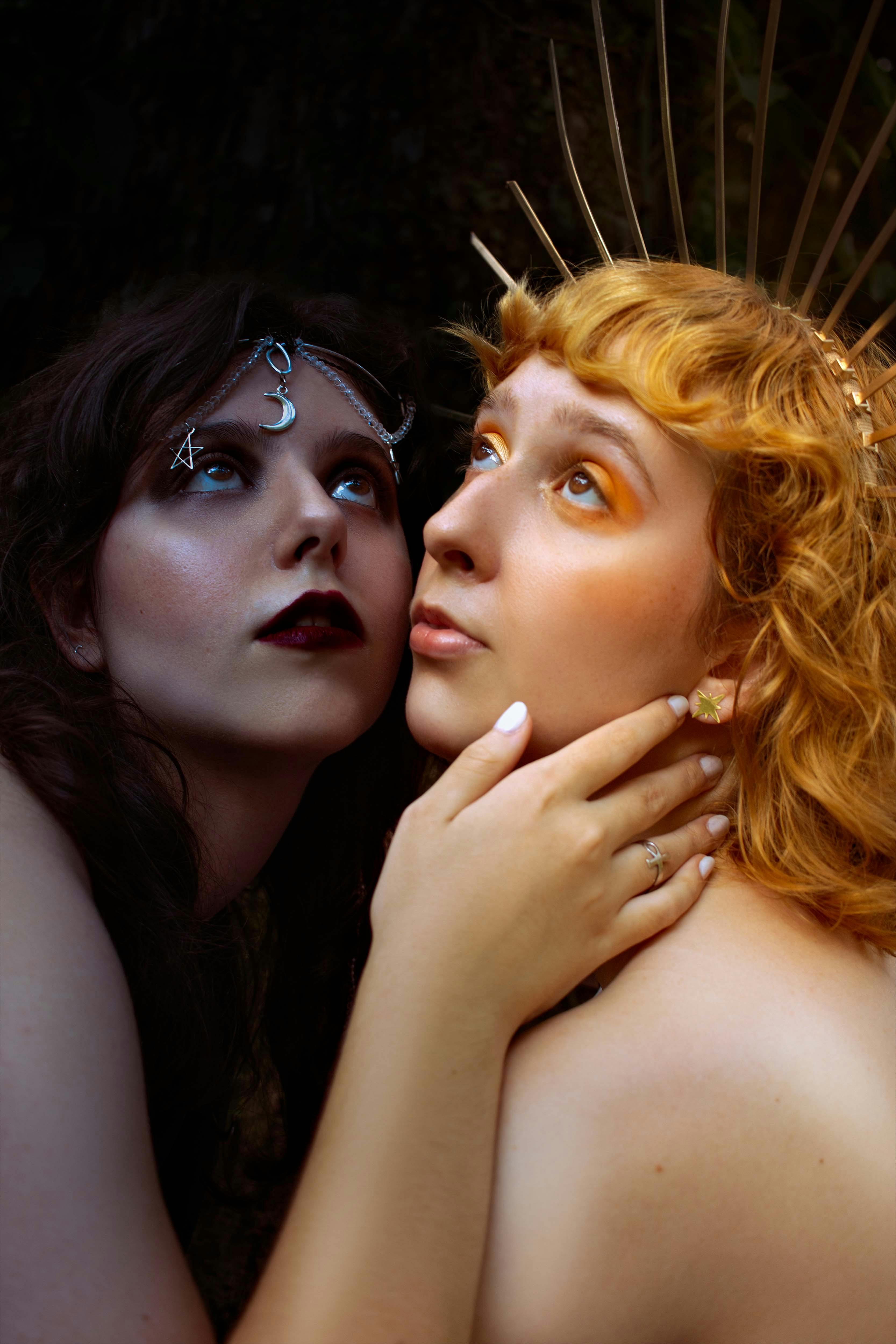 women posing in creative makeup and crowns