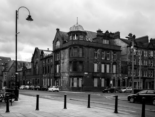 Grayscale Photo of Old Building on Street Corner