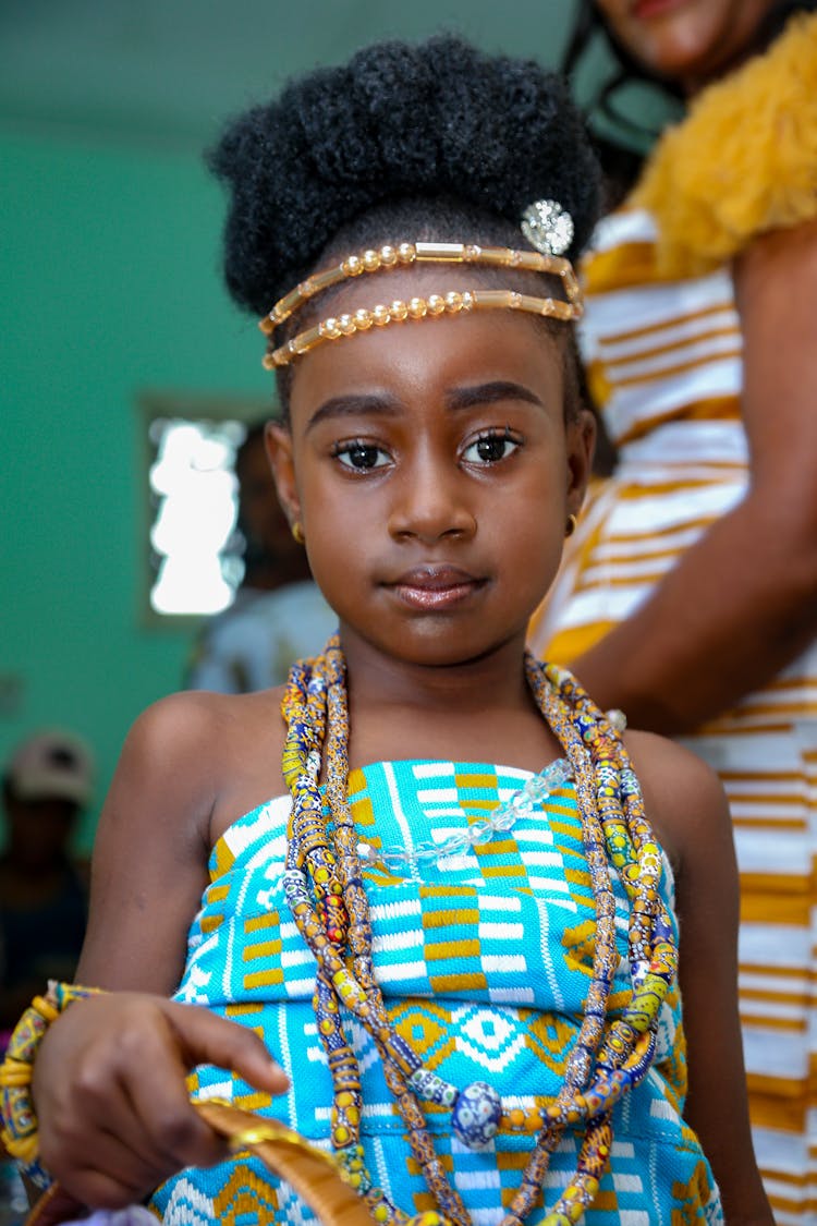 Girl Wearing Beaded Necklaces And Headband