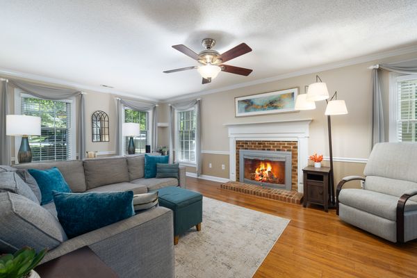 Sitting room with a lit fireplace and deep sofas — photo by Curtis Adams on Pexels