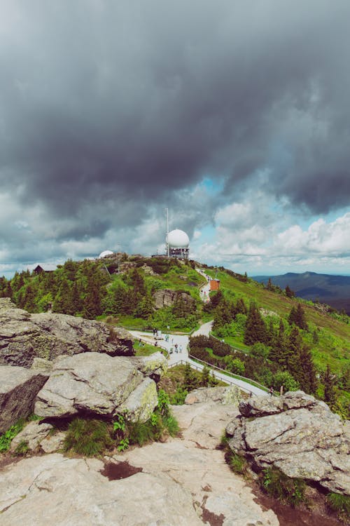 Free stock photo of buildings, clouds, hill