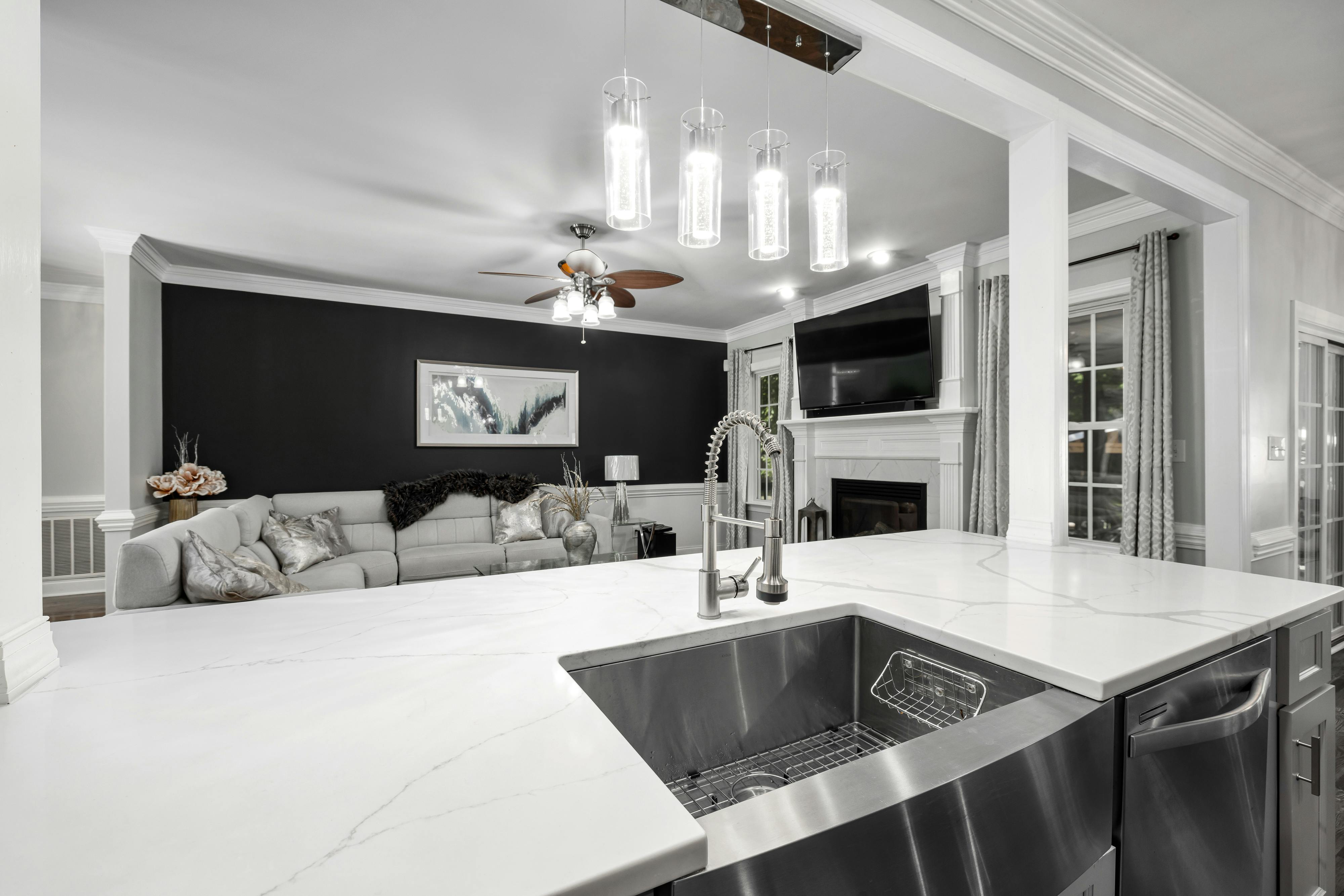 Elegant open space kitchen and living area with modern fixtures and decor.