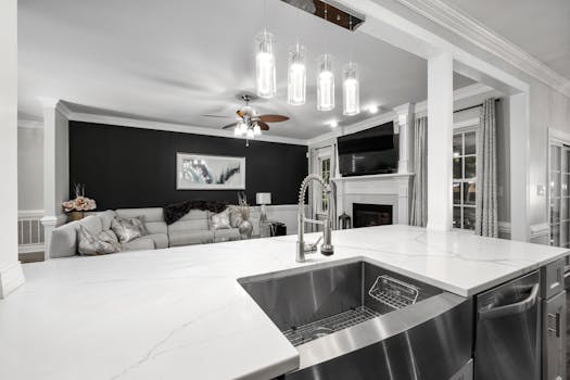Elegant open space kitchen and living area with modern fixtures and decor.