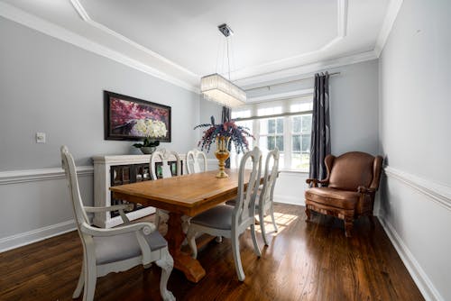Brown Wooden Dining Table With White Chairs