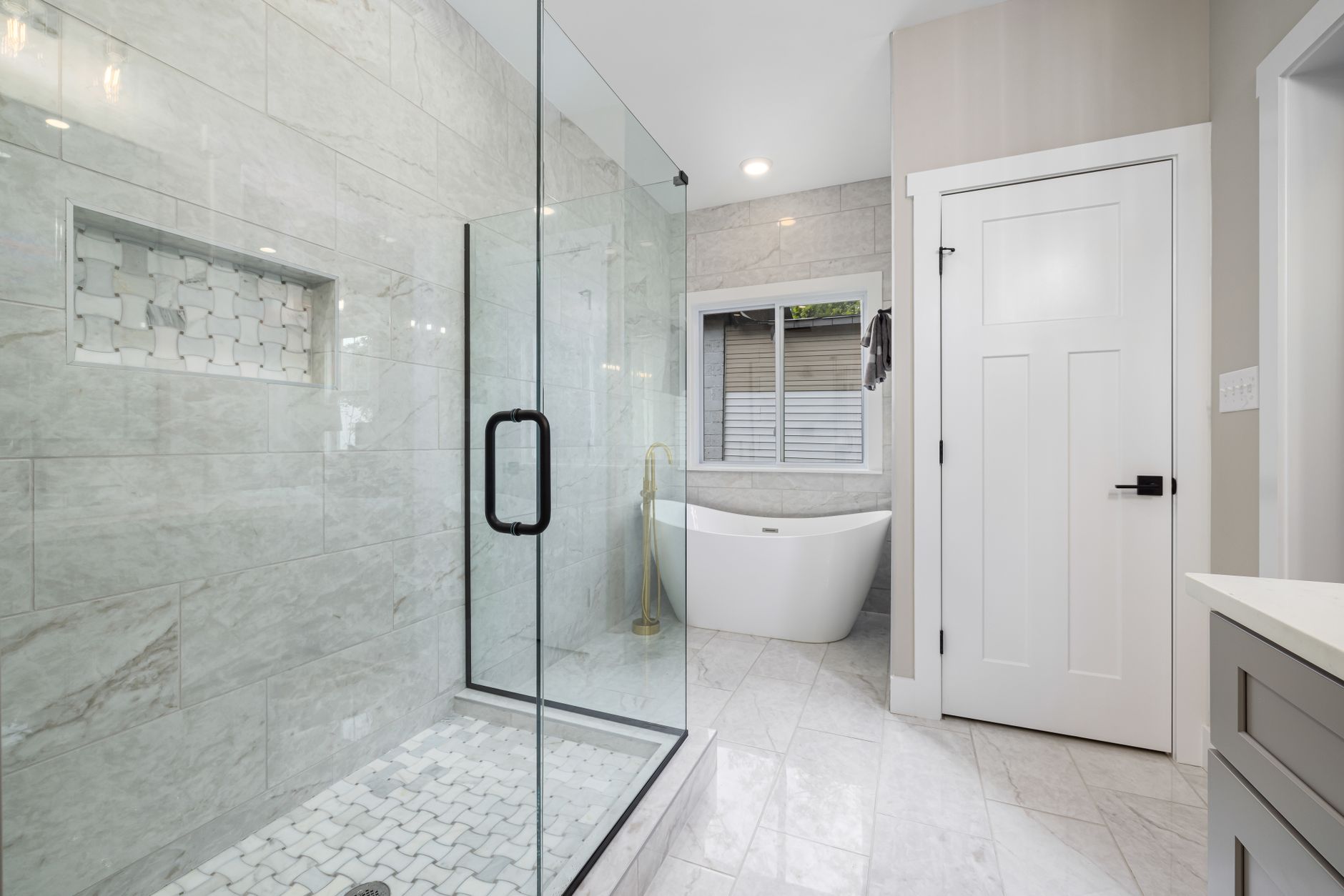 Modern bathroom with a glass shower and freestanding tub, a Cambridge bathroom renovation example. Modern bathroom with a glass shower and freestanding tub, a Cambridge bathroom renovation example.