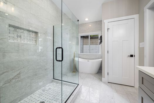 Bright modern bathroom featuring a glass shower and freestanding bathtub. Perfect for design inspiration.