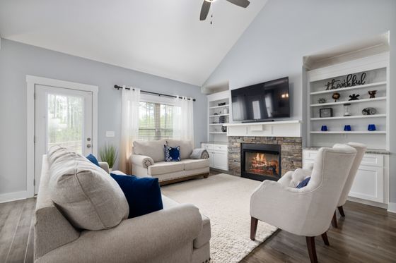 Bright living room with a fireplace and seating — photo by Curtis Adams on Pexels