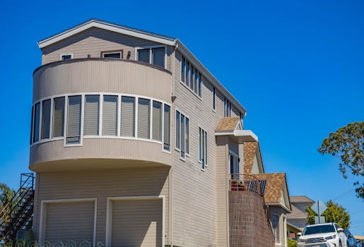 A modern suburban house with unique architectural design and clear blue sky backdrop.