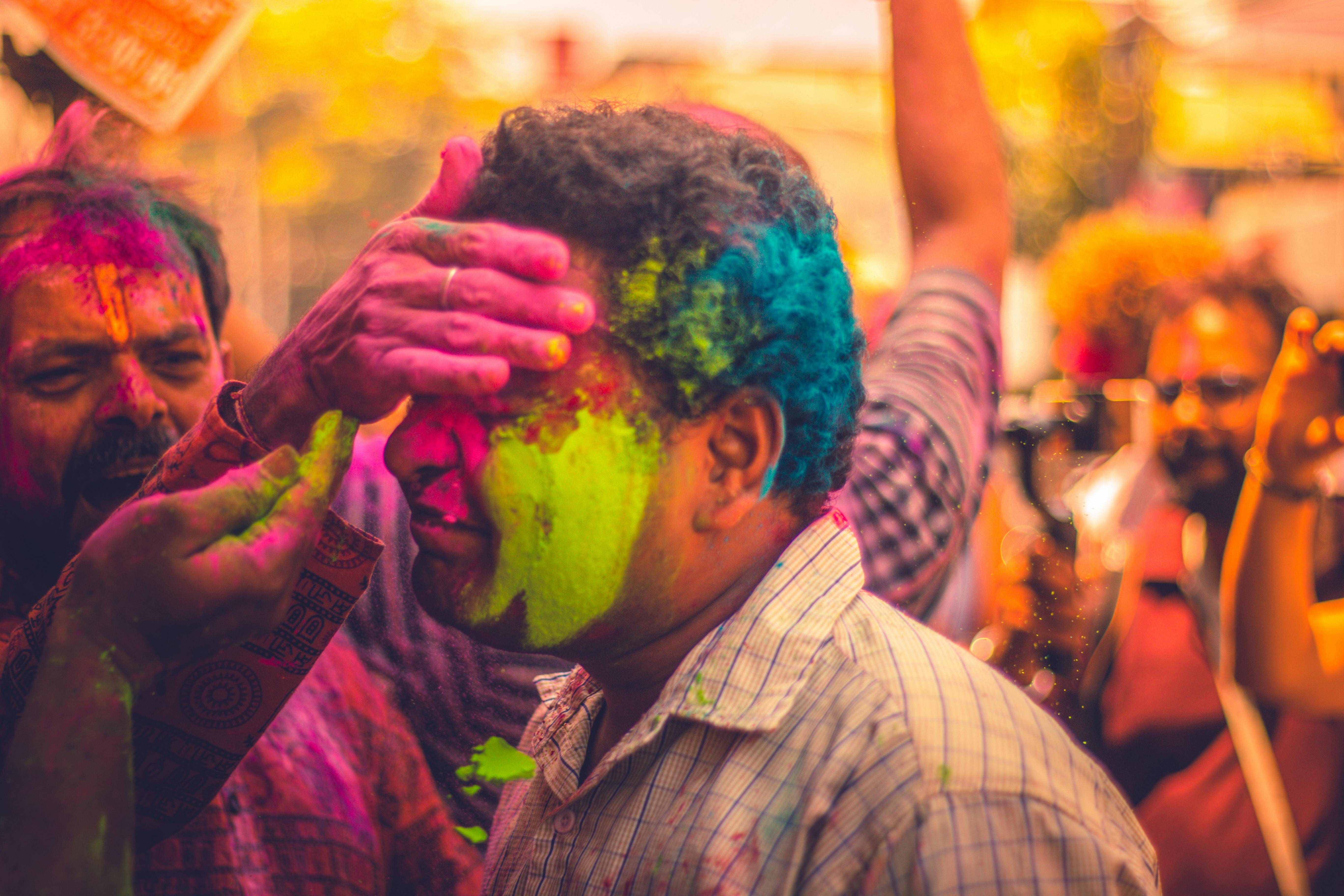 People celebrate Holi with vibrant colors in Kochi, India, showcasing joy and culture.