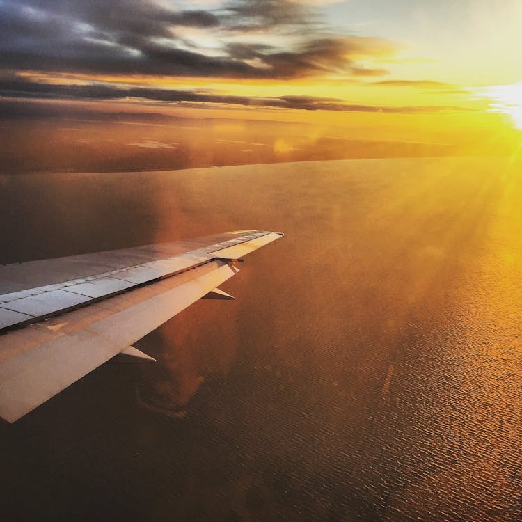 Aerial Photography of Plane Wing during Sunset