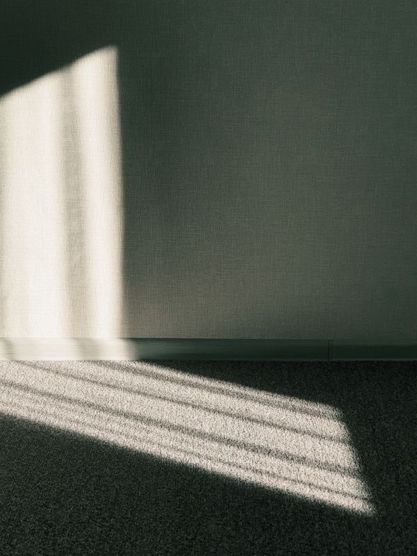 Daylight falling across a bare wall and floor — photo by Dmitry Alexandrovich on Pexels