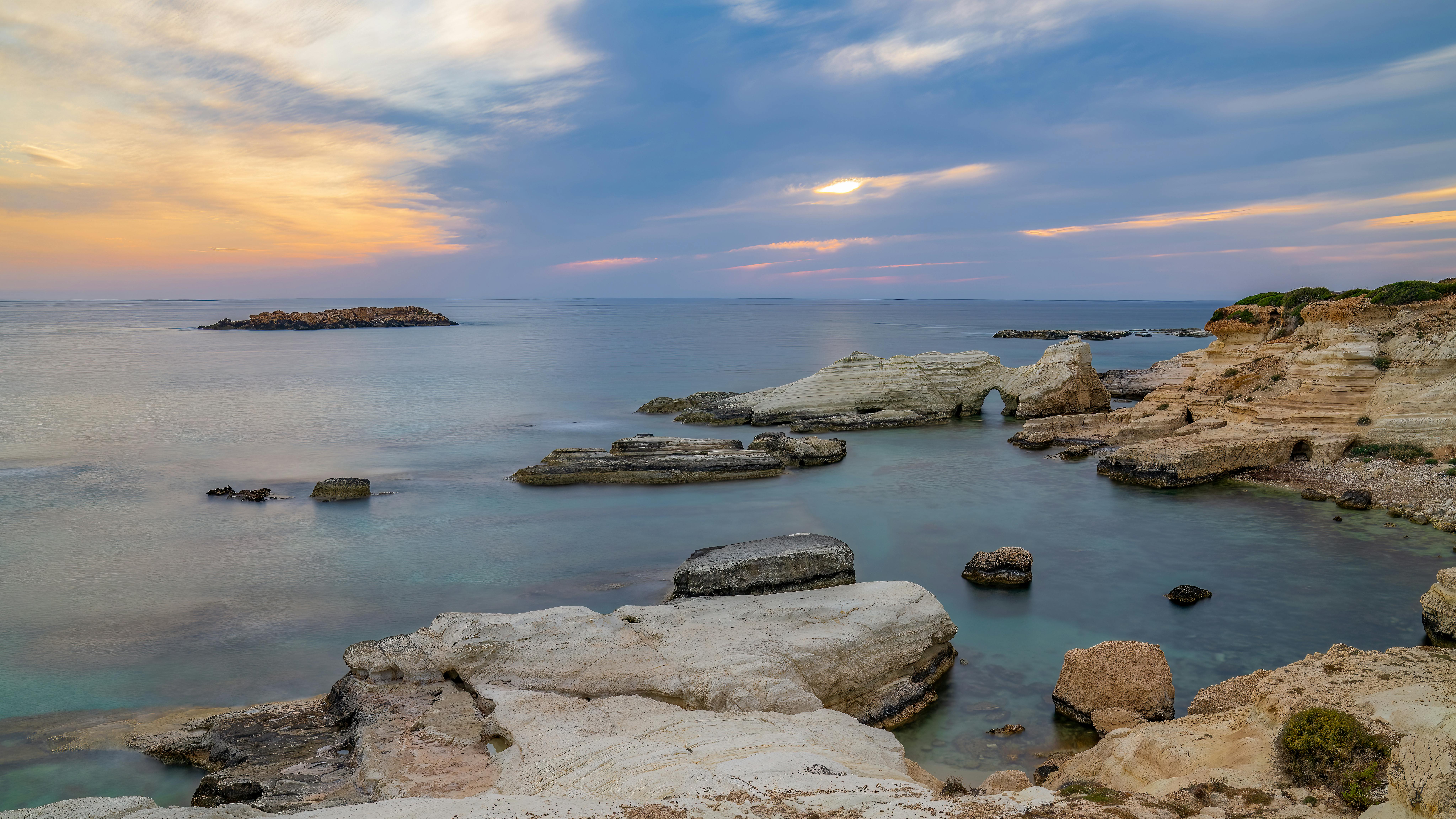 Peaceful sunset over a rocky coastline with ocean view in Cyprus. Ideal for travel and nature themes. - Photo by chris clark on Pexels