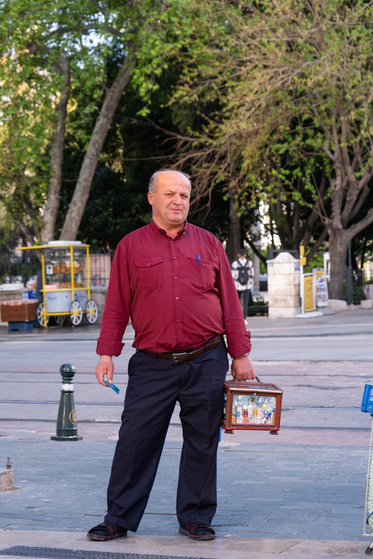 Mature Man Standing On A Town Square 