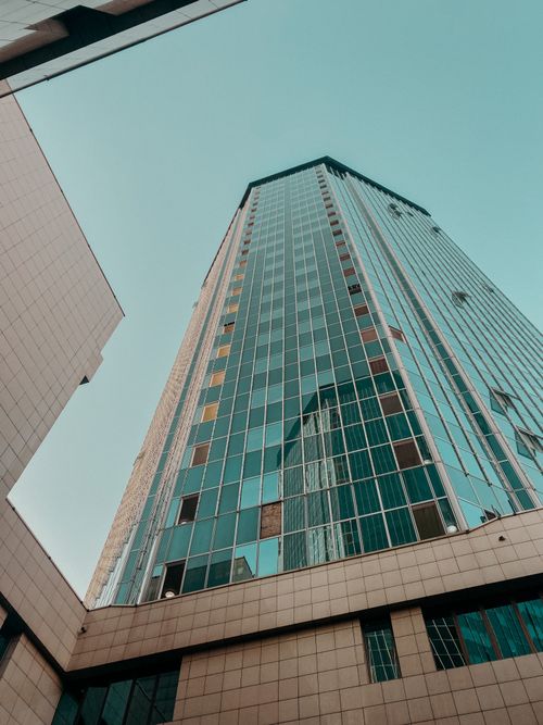 Free Impressive low angle view of a modern skyscraper in Almaty, Kazakhstan against a clear sky. Stock Photo