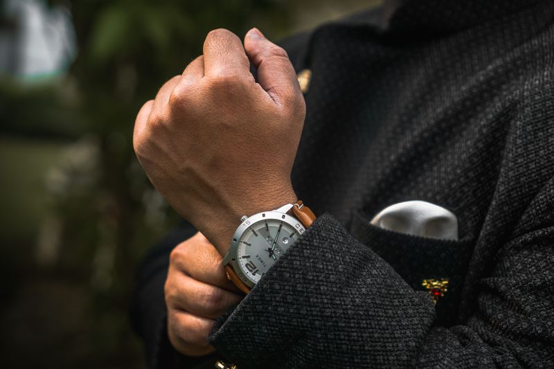 A steel watch worn under a jacket cuff — photo by Vishnu Panday on Pexels