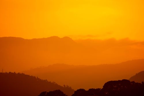 Free A stunning sunset silhouette of mountains in Nepal, capturing nature's dramatic orange hues. Stock Photo