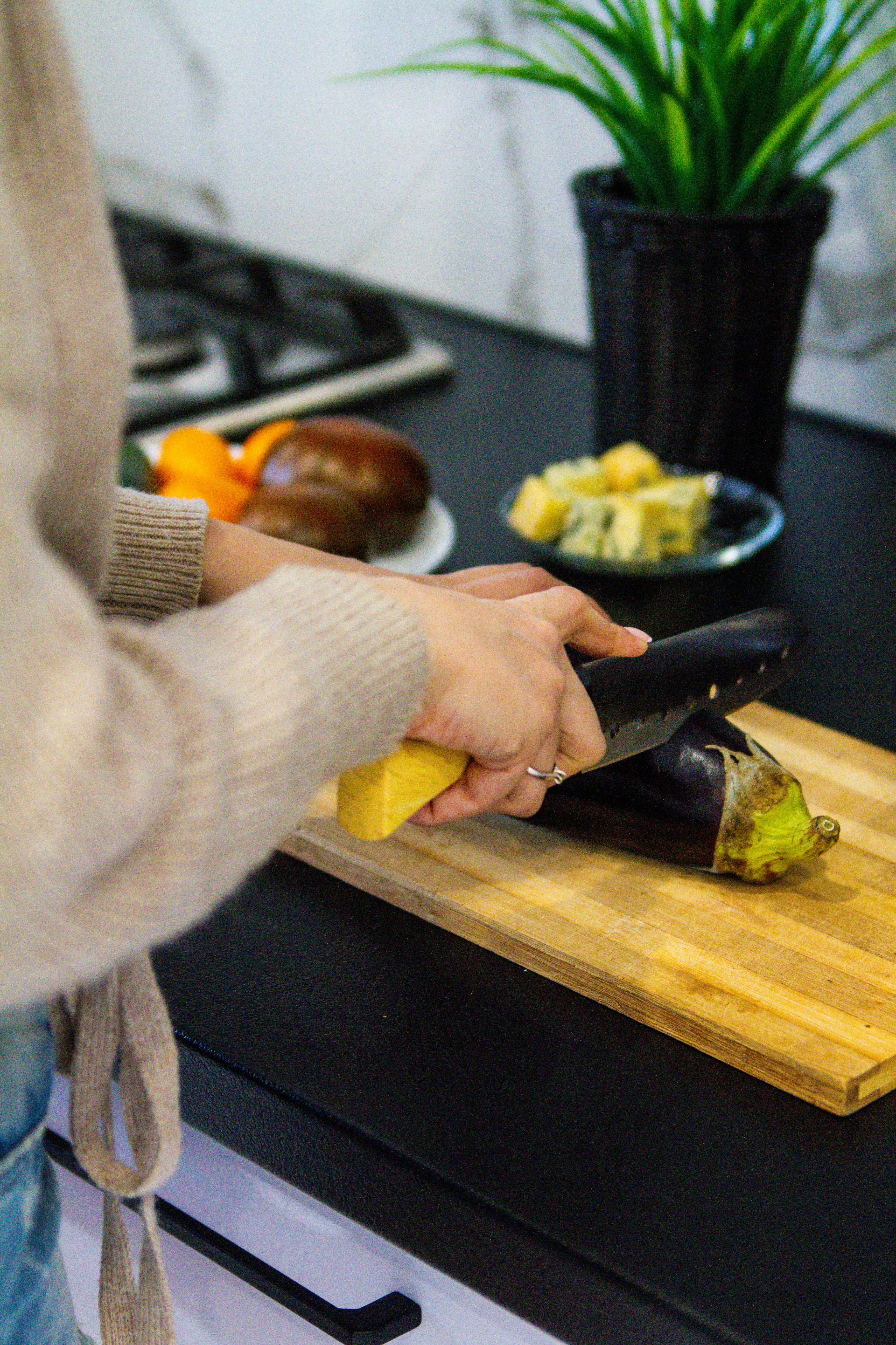 Close-Up Shot of a Knife and Sliced Vegetables on a Wooden Chopping Board ·  Free Stock Photo