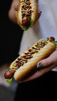 Close-up of tasty hot dogs with mustard and lettuce, perfect for food photography.